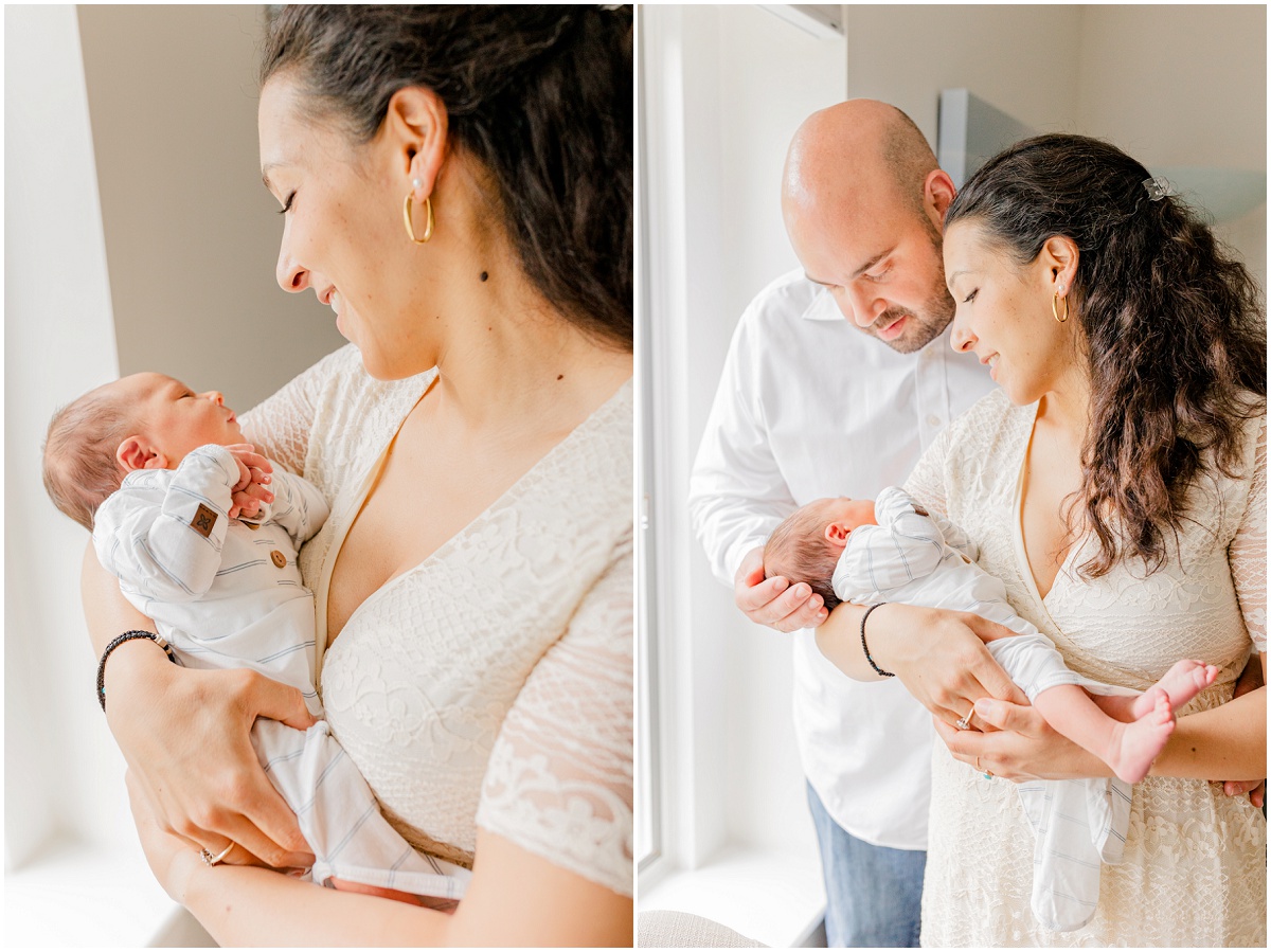 Mother looking down and smiling at newborn baby in her arms; mother and dad standing and holding the baby, gazing down at his face