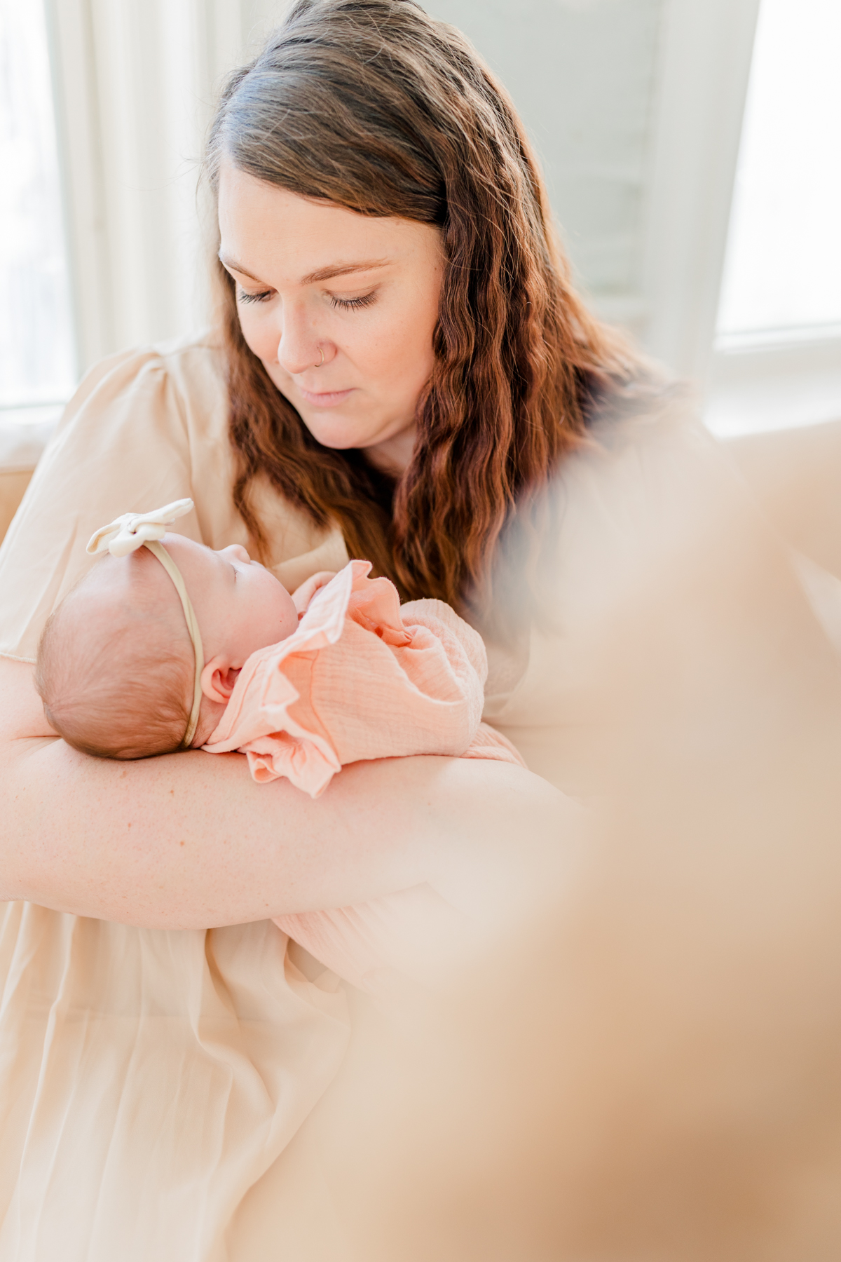 North Shore Newborn Photography - Mother gazing down at newborn in her arms