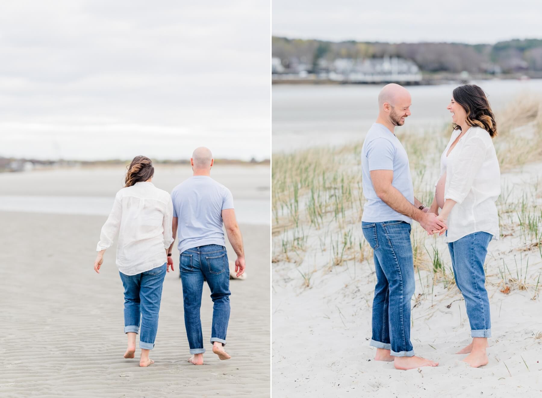 A mom to be walks down a beach while holding hands with her husband both in jeans cambridge doulas